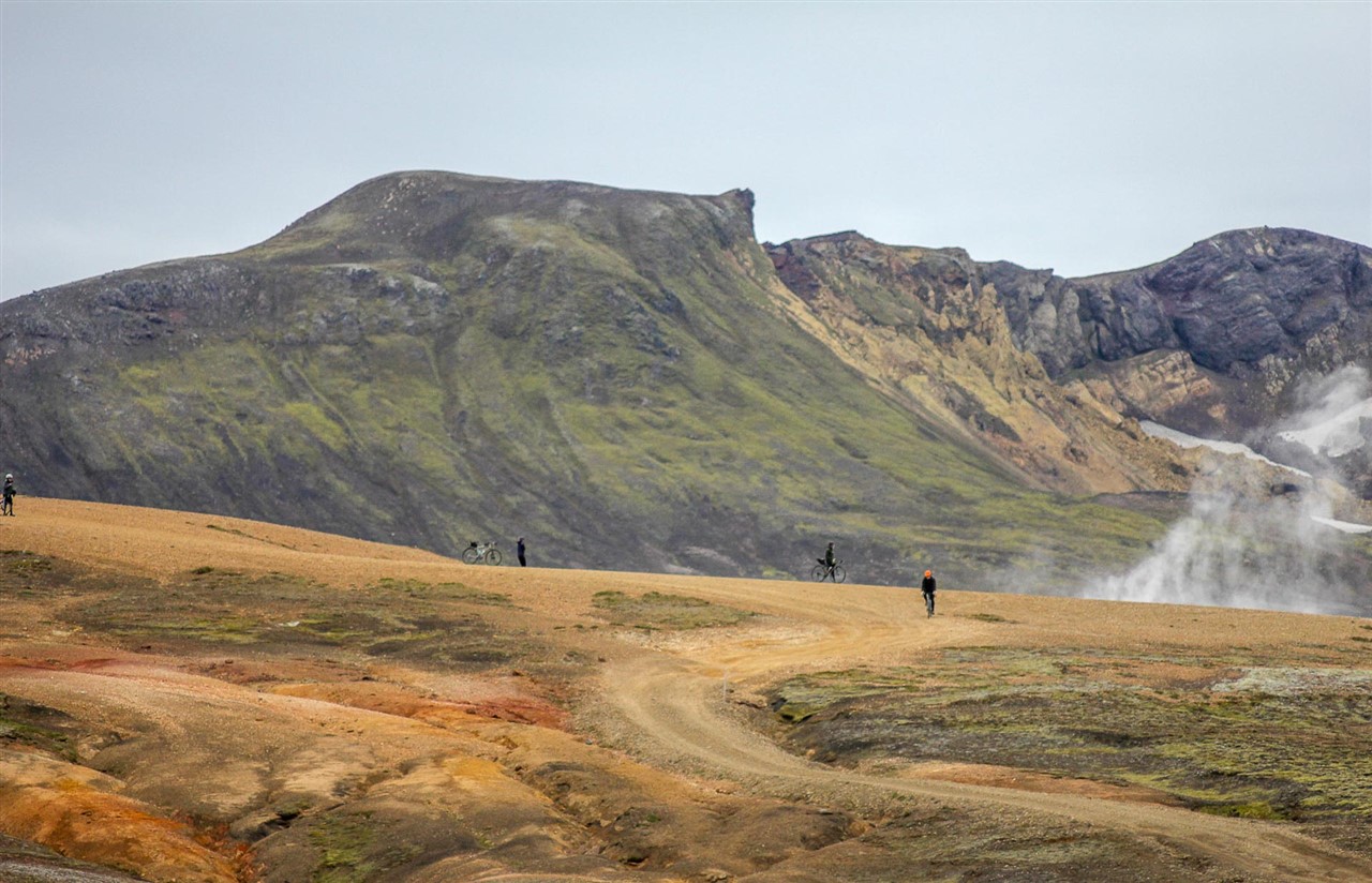 https://icebikeadventures.com/wp-content/uploads/2023/02/Gravel-riders-cycling-by-a-geothermal-area-in-Iceland.jpg