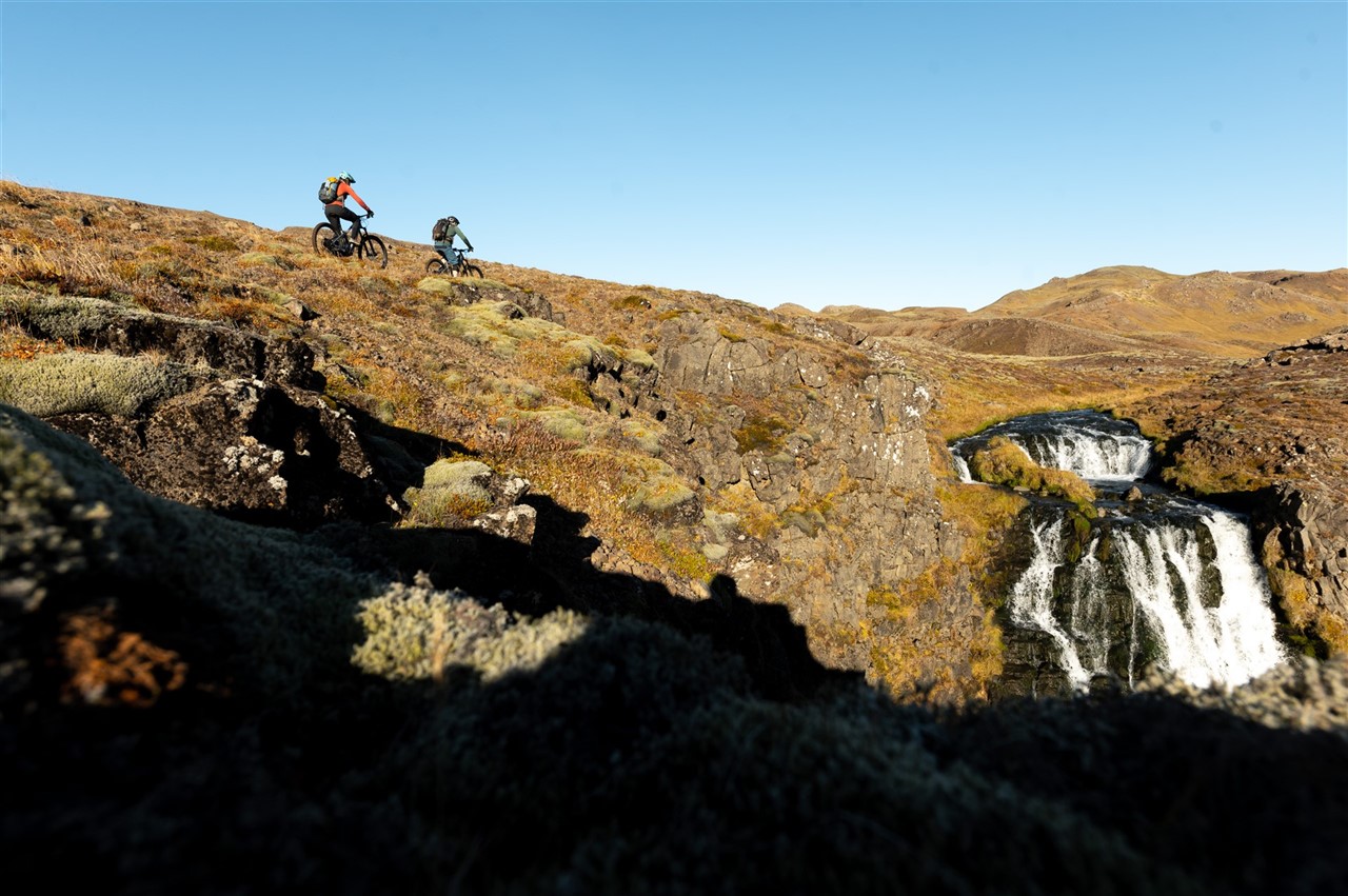 https://icebikeadventures.com/wp-content/uploads/2023/02/One-of-the-epic-trails-of-Icebike-trailcenter-leads-you-to-the-top-of-this-waterfall.jpg